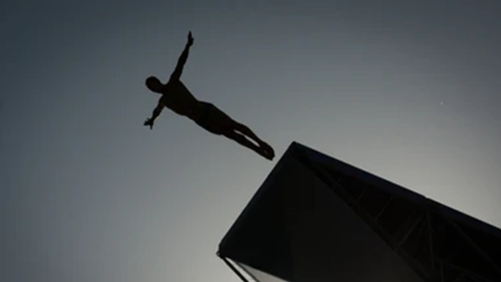 A high diving board above a pool, representing the spiritual leap of faith required for temple preparation.