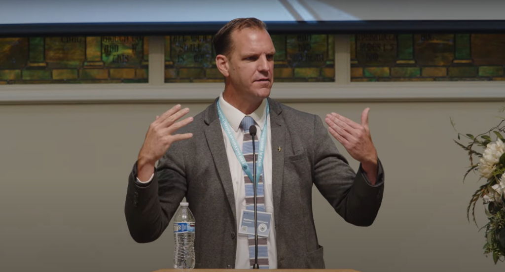 Speaker Matt Christiansen delivering a presentation at the FAIR Conference on preparing youth for meaningful temple experiences.